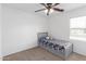 This bedroom has carpet, a ceiling fan, and a bed with stuffed animals at 4445 E Coconino St, Phoenix, AZ 85044
