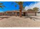 Charming single-story home featuring desert landscaping and a desert palm tree in front at 4445 E Coconino St, Phoenix, AZ 85044