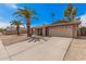 A charming single-story home with a spacious driveway and desert landscaping at 4445 E Coconino St, Phoenix, AZ 85044