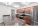 Open kitchen with stainless steel appliances, light countertops, and wood cabinetry at 4445 E Coconino St, Phoenix, AZ 85044
