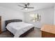 This main bedroom has neutral paint, a ceiling fan, and a window with natural light at 4445 E Coconino St, Phoenix, AZ 85044