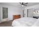 This main bedroom offers carpet, a ceiling fan, and a closet with mirrored doors at 4445 E Coconino St, Phoenix, AZ 85044
