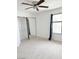 Neutral carpeted bedroom with ceiling fan, closet, window, and blue curtain at 461 W Holmes Ave # 374, Mesa, AZ 85210