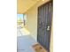 Secure front door with iron gate and pineapple welcome mat; inviting entry to a charming home at 461 W Holmes Ave # 374, Mesa, AZ 85210