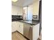 Updated kitchen features white cabinets, backsplash, new appliances, and sink at 461 W Holmes Ave # 374, Mesa, AZ 85210