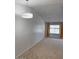 Bright living room boasting neutral carpet, vaulted ceilings, and a large window for plenty of natural light at 461 W Holmes Ave # 374, Mesa, AZ 85210