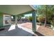 Cozy covered patio with stone tile and a view of the backyard's landscaping at 5153 W Topeka Dr, Glendale, AZ 85308