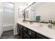 Bathroom featuring double sink vanity, plenty of counter space, framed mirrors, and updated fixtures at 5153 W Topeka Dr, Glendale, AZ 85308