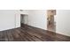 Spacious bedroom featuring modern wood floors, white walls and trim, and multiple closets for ample storage at 5153 W Topeka Dr, Glendale, AZ 85308