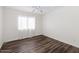 Bright bedroom with vinyl wood-look flooring, neutral walls and a window offering natural light at 5153 W Topeka Dr, Glendale, AZ 85308