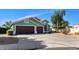 Charming home with a three-car garage and desert landscaping for low maintenance at 5153 W Topeka Dr, Glendale, AZ 85308