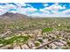 Amazing aerial view of desert community homes with golf course and mountain views at 6214 E Evening Glow Dr, Scottsdale, AZ 85266
