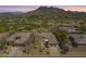 Scenic aerial view of a home, golf course, and mountain views in a beautiful community at 6214 E Evening Glow Dr, Scottsdale, AZ 85266