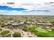 Stunning aerial of community home with golf course and mountain views at 6214 E Evening Glow Dr, Scottsdale, AZ 85266