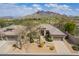 Aerial view of a Southwestern home with desert landscaping and a tile roof at 6214 E Evening Glow Dr, Scottsdale, AZ 85266