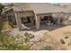 Inviting back patio with brick flooring, a built-in firepit, and outdoor seating, perfect for relaxation at 6214 E Evening Glow Dr, Scottsdale, AZ 85266