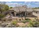 Beautiful backyard featuring a covered patio, fire pit, desert landscaping, and a privacy fence at 6214 E Evening Glow Dr, Scottsdale, AZ 85266