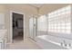 Well-lit bathroom with glass enclosed shower and soaking tub at 6214 E Evening Glow Dr, Scottsdale, AZ 85266