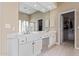 Bright bathroom with double vanity, white cabinets, and walk-in closet at 6214 E Evening Glow Dr, Scottsdale, AZ 85266