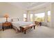 Primary bedroom with large windows, bench seat, and ceiling fan at 6214 E Evening Glow Dr, Scottsdale, AZ 85266
