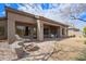 Spacious covered patio with outdoor seating, a fire pit, and desert landscape views at 6214 E Evening Glow Dr, Scottsdale, AZ 85266