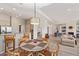 Open concept, naturally lit dining area featuring a round table and chairs, and view to kitchen and living areas at 6214 E Evening Glow Dr, Scottsdale, AZ 85266