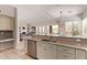 Kitchen with a breakfast bar and sink overlooking the naturally lit living room with tile flooring at 6214 E Evening Glow Dr, Scottsdale, AZ 85266