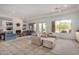 Bright living room featuring tile floors, fireplace, large windows and comfortable seating arrangement at 6214 E Evening Glow Dr, Scottsdale, AZ 85266