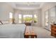 Bright main bedroom with golf course views, neutral walls, lots of windows and access to covered patio at 6214 E Evening Glow Dr, Scottsdale, AZ 85266