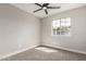 Bright bedroom with a large window, neutral walls, carpet, and modern ceiling fan at 6335 E Brown Rd # 1098, Mesa, AZ 85205