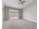 Bedroom showcasing neutral carpet, a ceiling fan and sliding glass doors to the yard at 6335 E Brown Rd # 1098, Mesa, AZ 85205