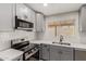 Updated kitchen featuring stainless steel appliances, gray cabinetry, and a modern backsplash at 6335 E Brown Rd # 1098, Mesa, AZ 85205