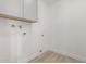 Bright laundry room with white walls, vinyl floors, and white cabinets at 6335 E Brown Rd # 1098, Mesa, AZ 85205