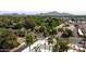 The aerial view showcases lush trees, stunning mountain views, and palm-lined streets surrounding the home at 6540 N 7Th Ave # 46, Phoenix, AZ 85013