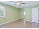 Bedroom with light green walls, ceiling fan, hardwood flooring, and natural light at 6540 N 7Th Ave # 46, Phoenix, AZ 85013