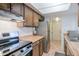 Traditional kitchen features stainless steel appliances, wood cabinets, and a neutral countertop space at 6540 N 7Th Ave # 46, Phoenix, AZ 85013
