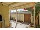 Covered patio with a charming landscape, blooming bougainvillea, and access to the backyard at 6540 N 7Th Ave # 46, Phoenix, AZ 85013