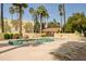 Inviting community pool area with lounge chairs, tables, and beautifully landscaped surroundings at 6540 N 7Th Ave # 46, Phoenix, AZ 85013