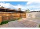 Enclosed backyard showcasing a wood fence, brick paved patio, block wall, and shade structure at 6711 W Osborn Rd # 68, Phoenix, AZ 85033