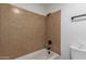 Bathroom features a tile lined shower and bath, with coordinating hardware at 6711 W Osborn Rd # 68, Phoenix, AZ 85033