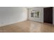 Bright bedroom with neutral tile flooring, a window providing natural light, and fresh white walls at 6711 W Osborn Rd # 68, Phoenix, AZ 85033
