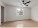 Bright bedroom with neutral walls and flooring, and a window overlooking the fenced yard at 6711 W Osborn Rd # 68, Phoenix, AZ 85033