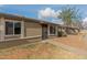 Property featuring pathway to the front door, tan stucco exterior, and well maintained rock landscaping at 6711 W Osborn Rd # 68, Phoenix, AZ 85033