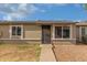 Home exterior with a desert landscape, pathway to a secure front door, and large windows at 6711 W Osborn Rd # 68, Phoenix, AZ 85033