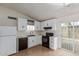 Bright kitchen with white cabinets, modern appliances, and neutral tile flooring for a seamless look at 6711 W Osborn Rd # 68, Phoenix, AZ 85033