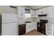 Modern kitchen with white cabinets, sleek countertops, and black appliances for a crisp, clean design at 6711 W Osborn Rd # 68, Phoenix, AZ 85033