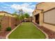Backyard featuring low-maintenance turf, well-placed landscaping, and a patio area at 6904 W Ashby Dr, Peoria, AZ 85383