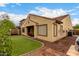 Outdoor view of a well-maintained yard featuring a patio area and stucco home exterior at 6904 W Ashby Dr, Peoria, AZ 85383