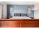 Well-lit bedroom with plush bed and end tables with decorative accent wall at 6904 W Ashby Dr, Peoria, AZ 85383
