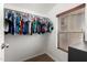 Well-lit walk-in closet featuring neutral carpeting, organized clothing, and natural lighting at 6904 W Ashby Dr, Peoria, AZ 85383